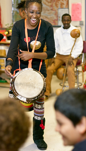 African drummer playing in a school classroom